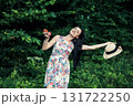 A cute woman with two red apples in the forest 131722250