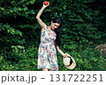 A cute woman with two red apples in the forest 131722251