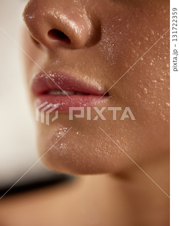 Close-up of wet glossy lips and fresh hydrated skin after skincare treatment 131722359