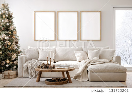 Cozy living room decorated for the holidays with a stylish sofa, festive tree, and warm natural light. Empty vertical frames set of 3 for wall art mockup. 131723201