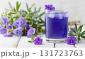 Discover the refreshing blue butterfly pea flower drink, a beautiful beverage infused with vibrant petals and ice, perfect for warm summer days and special occasions 131723763