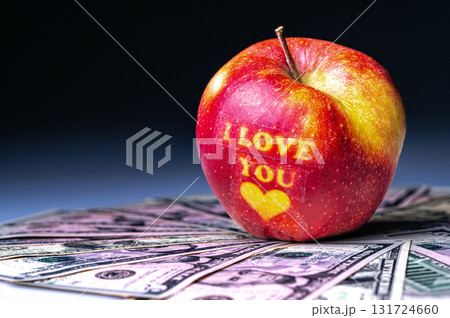 I love You apple with heart on dollar banknotes. The concept of love and prosperity. Closeup 131724660