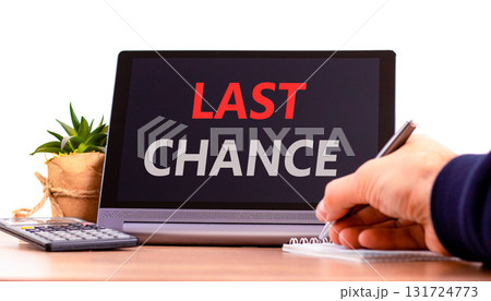 Last chance symbol. Concept word Last chance on beautiful black tablet. Businessman's hand with pen. Calculator. Beautiful white background. Business last chance concept. Copy space. 131724773