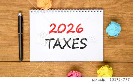 2026 taxes new year symbol. Concept words 2026 taxes on beautiful white note. Beautiful wooden background. Black pen. Colored paper. Business and 2026 taxes new year concept. Copy space. 131724777