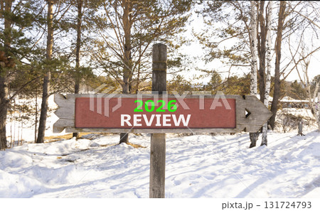 2026 Review symbol. Concept words 2026 Review on beautiful wooden road sign. Beautiful winter forest background. Business and 2026 review concept. Copy space. 2026 Review symbol. Concept words 2026 Review on beautiful wooden road sign. Beautiful winter forest background. Business and 2026 review concept. Copy space. 131724793