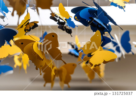 ceiling decorated with decorative colored paper butterflies, selective focus, blurred background ceiling decorated with decorative colored paper butterflies, selective focus, blurred background 131725037
