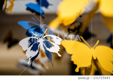 ceiling decorated with decorative colored paper butterflies, selective focus, blurred background ceiling decorated with decorative colored paper butterflies, selective focus, blurred background 131725043