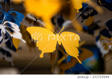 ceiling decorated with decorative colored paper butterflies, selective focus, blurred background ceiling decorated with decorative colored paper butterflies, selective focus, blurred background 131725044