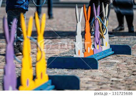 wooden bunny figures for throwing rings, Easter holidays, games for children in the town square wooden bunny figures for throwing rings, Easter holidays, games for children in the town square 131725686