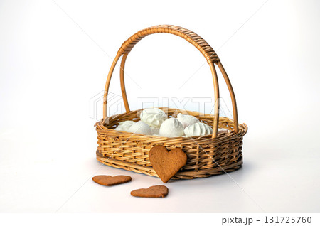 wicker basket with meringue cookies from egg whites, selective focus, closeup, isolated, copy space wicker basket with meringue cookies from egg whites, selective focus, closeup, isolated, copy space 131725760