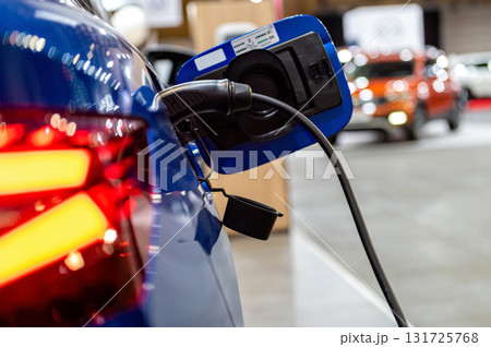 electric car connected to the charger, eco friendly technology, charging an electric car battery 131725768