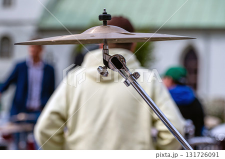 Part of a drum kit on a defocused background with a human silhouette, close-up Part of a drum kit on a defocused background with a human silhouette, close-up 131726091