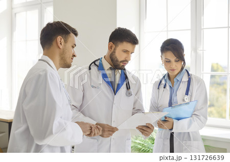 Medical gathering talk, council of physicians, doctors discussion using paper documents, sharing Medical gathering talk, council of physicians, doctors discussion using paper documents, sharing 131726639