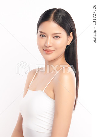 A beautiful young Asian woman with clean, fresh skin against a white background. Skincare, facial treatment, cosmetology, beauty, and spa. An elegant portrait of an Asian woman. A beautiful young Asian woman with clean, fresh skin against a white background. Skincare, facial treatment, cosmetology, beauty, and spa. An elegant portrait of an Asian woman. 131727326