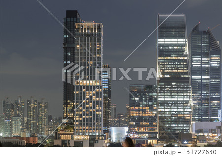 the illuminated high-rise buildings and skyscrapers of Bangkok city at night. 131727630