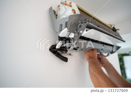 Damaged insulation on copper pipe of indoor air conditioner unit causing water leakage down wall 131727809