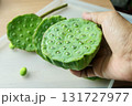 Hand Holding Fresh Lotus Seed Pods for Snack 131727977