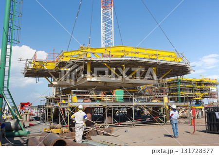 Heavy crane in oil rig construction work. Heavy crane in oil rig construction work. 131728377