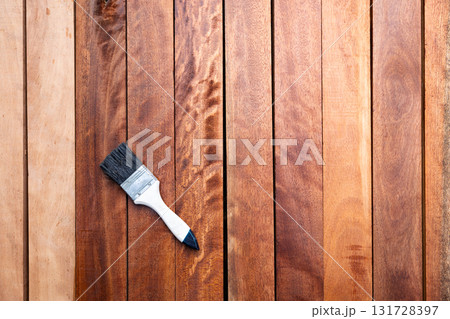 Paint brush and wood material in construction work. Paint brush and wood material in construction work. 131728397