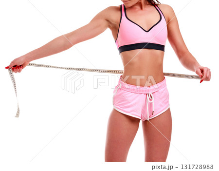 Fitness woman with measure tape isolated on white background Fitness woman with measure tape isolated on white background 131728988