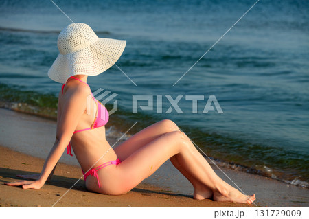 Sexy woman posing on a sea beach 131729009