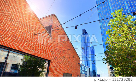 Glass office building surrounded with green trees. Eco-friendly office building. Sustainable architecture of city reducing heat carbon dioxide modern city environment. Glass office building surrounded with green trees. Eco-friendly office building. Sustainable architecture of city reducing heat carbon dioxide modern city environment. 131729299