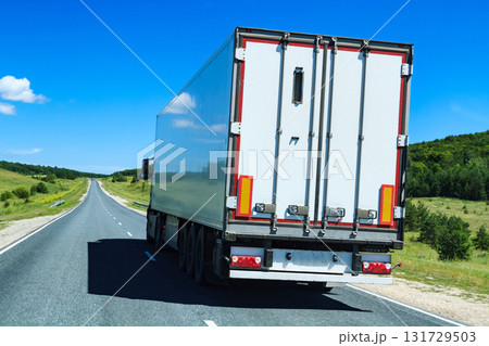Picture of big truck with the trailer moves on the highway 131729503