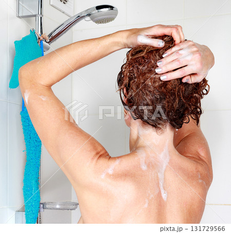 Closeup shot of woman washing her hair in a shower Closeup shot of woman washing her hair in a shower 131729566
