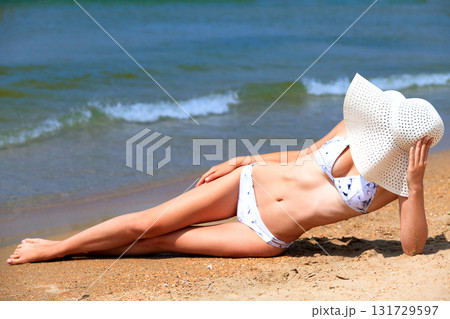 Slim woman on a beach. Summer holidays 131729597