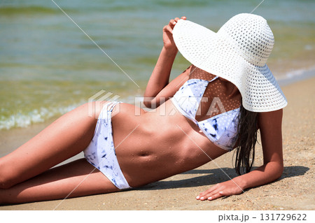 Slim woman on a beach. Summer holidays 131729622