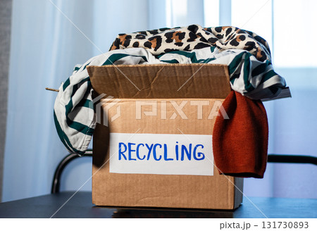 Large box packed with old clothes that are prepared for recycling. Image for Upcycling services. Zero waste concept. Large box packed with old clothes that are prepared for recycling. Image for Upcycling services. Zero waste concept. 131730893