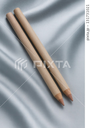 Pair of Sharpened Cosmetic Pencils on Luxurious Satin Fabric Pair of Sharpened Cosmetic Pencils on Luxurious Satin Fabric 131731021