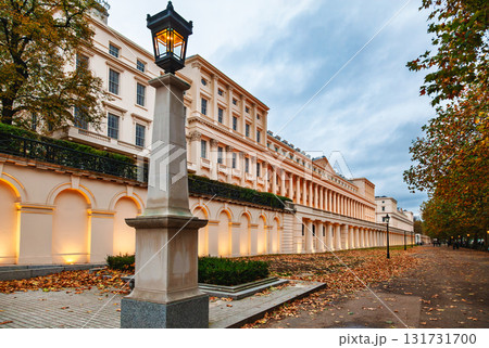 Elegant neoclassical building with illuminated facade and autumn trees in London 131731700