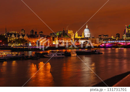 Night view of St Pauls Cathedral and illuminated city buildings reflected in River Thames in London 131731701