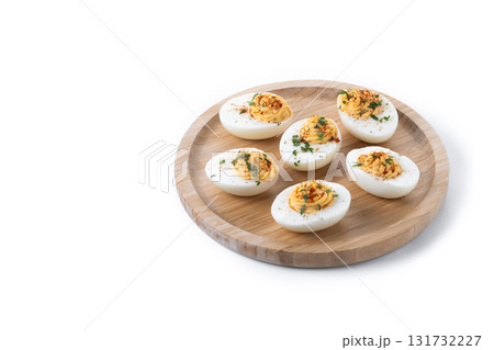 Homemade hard Boiled Deviled Eggs garnished with herbs 131732227