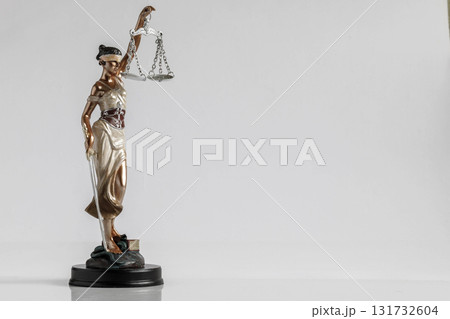 Symbol of justice holding scales in a serene setting. 131732604