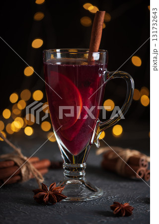 Glass of Mulled Wine with Citrus and Cinnamon on Festive Dark Background Glass of Mulled Wine with Citrus and Cinnamon on Festive Dark Background 131732643