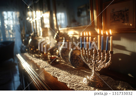 A festive menorah stands on a dresser, surrounded by pictures on the wall. Hanukkah. Home comfort. Candles in the menorah. A festive menorah stands on a dresser, surrounded by pictures on the wall. Hanukkah. Home comfort. Candles in the menorah. 131733032