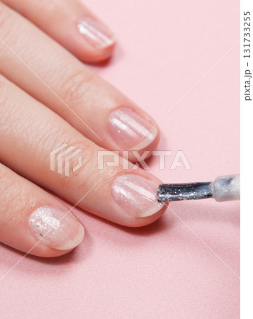 manicure in a beauty salon or at home, a woman paints her nails. manicure in a beauty salon or at home, a woman paints her nails. 131733255