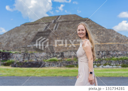 Female tourist standing in front of Teotihuacan pyramids in Mexico, enjoying sightseeing, adventure, and cultural heritage. Travel, tourism, and exploration concept 131734281