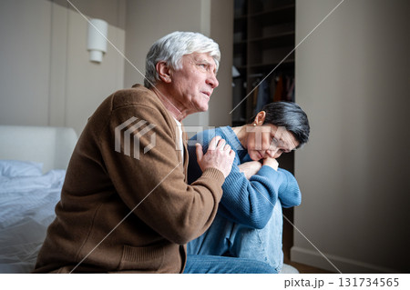 Elderly couple in grief and depression, man husband comforting woman with mental health struggles Elderly couple in grief and depression, man husband comforting woman with mental health struggles 131734565