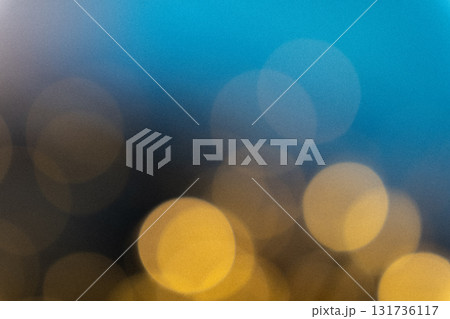Blue and golden bokeh light leak overlay effect, dreamy blurred glowing circles with vintage film grain texture, festive abstract background 131736117