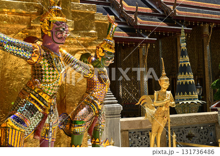 The large giant guardian standing guard carrying the pagoda base at Wat Phra Kaew Temple of the Emerald Buddha is a famous tourist attraction. Bangkok Thailand. The large giant guardian standing guard carrying the pagoda base at Wat Phra Kaew Temple of the Emerald Buddha is a famous tourist attraction. Bangkok Thailand. 131736486