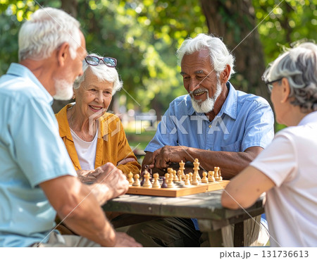 AI generated image of diverse seniors playing chess in a park with an AI-powered coach on a tablet. Natural light, joyful atmosphere, and social connection among friends. AI generated image of diverse seniors playing chess in a park with an AI-powered coach on a tablet. Natural light, joyful atmosphere, and social connection among friends. 131736613
