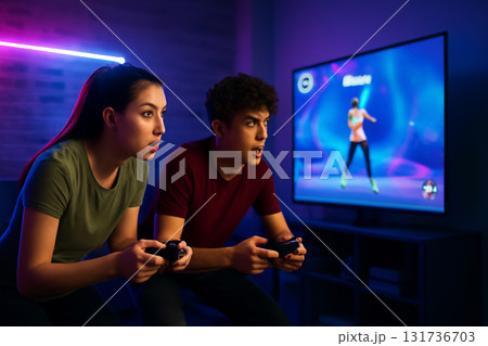 AI generated image of two teenagers intensely competing in a fitness video game. Neon-lit atmosphere with dynamic motion captures the competitive energy of youth in a modern rec room setting. AI generated image of two teenagers intensely competing in a fitness video game. Neon-lit atmosphere with dynamic motion captures the competitive energy of youth in a modern rec room setting. 131736703