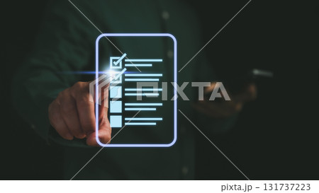 Businessman touching digital checklist interface with glowing checkboxes. Concept for online survey, task completion, project planning and productivity management in digital work environments. Businessman touching digital checklist interface with glowing checkboxes. Concept for online survey, task completion, project planning and productivity management in digital work environments. 131737223