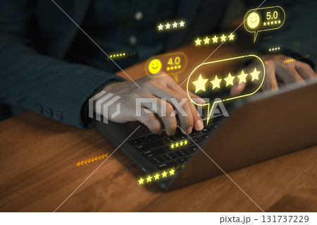 Customer typing on laptop computer with glowing 5 star review icons, symbolizing positive customer feedback, testimonial, online ratings and excellent service reputation in digital business platform. Customer typing on laptop computer with glowing 5 star review icons, symbolizing positive customer feedback, testimonial, online ratings and excellent service reputation in digital business platform. 131737229