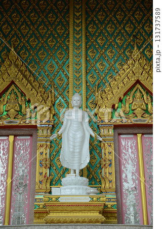 Standing white Buddha statue front of Thai Buddhist Church is enshrined at Wat Nong Yai. 131737589