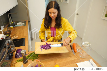 Young woman is broadcasting live from workshop how to prepare a vegetarian food Young woman is broadcasting live from workshop how to prepare a vegetarian food 131740089