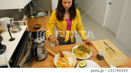 Young woman is broadcasting live from workshop how to prepare a vegetarian food Young woman is broadcasting live from workshop how to prepare a vegetarian food 131740193